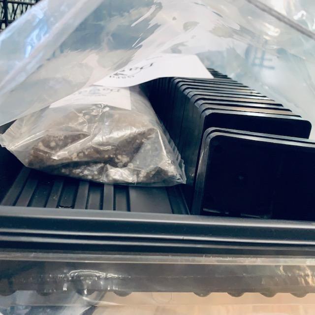 The inside of our germination kit comes with 2 trays, 18 small pots, a gallon of our germination mix, tags, a pen, instructions, our business card, and our ruler.
