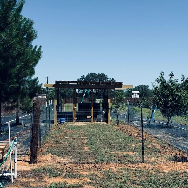 A fenced in yard for the goats is going up.