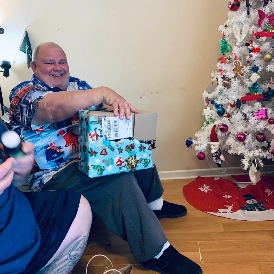 David opening a gift at Jeremy's house. It is rare that he smiles in photos so this is nice.