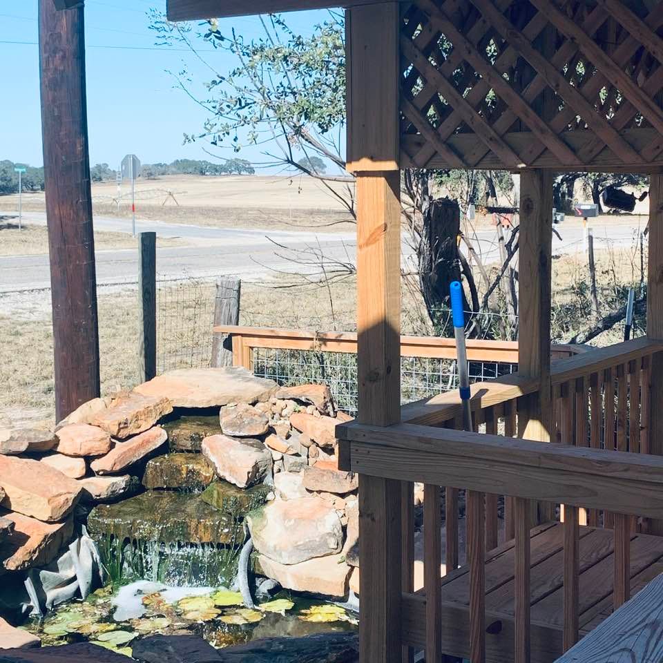 Our pond falls. In the distance, you can see the grass farm across from us diagonally. Blowing sand, trash, and debris is everywhere on this 35mph high wind day with gusts of up to 50mph.
