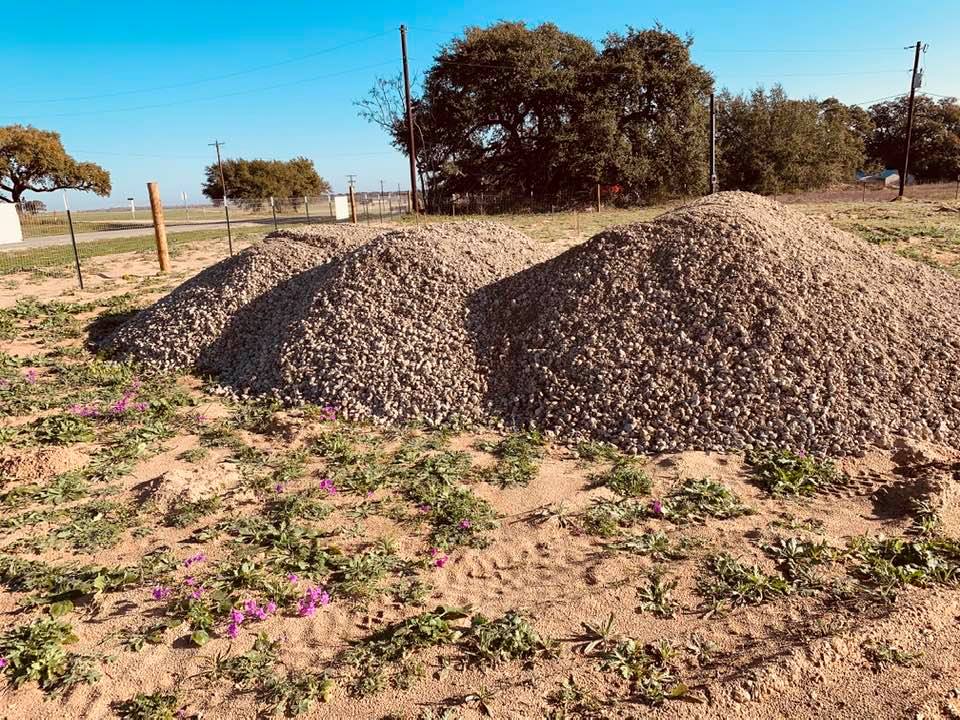 Gravel piles to smooth down to make our parking lot for David's Garden Seeds.