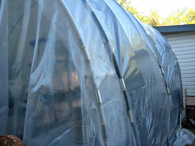 You can see the snap clamps holding the sheet plastic on the deck greenhouse.