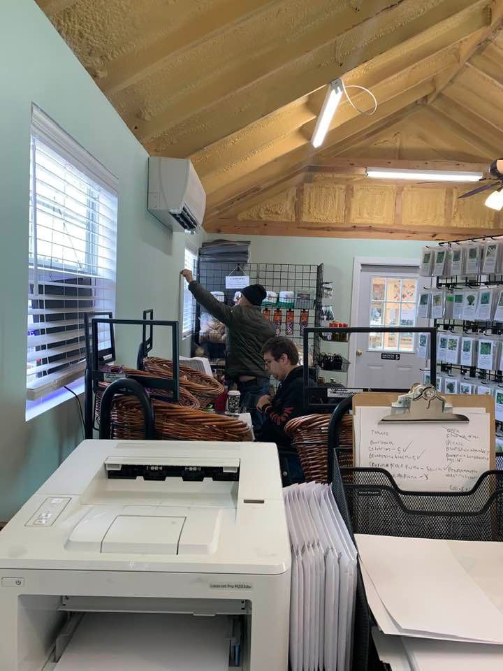 Matt is taking down some display racks and hanging them on another wall while Brendon is restocking the store. Linda is off on Thursdays. Too cold to do spring season outdoor work today.