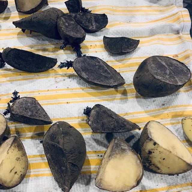 The purple potatoes are turning a bit white while drying out. My fingers are still slightly stained from cutting them yesterday.