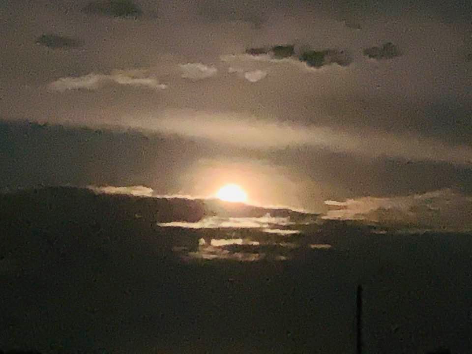 The moon is hiding behind some clouds.
