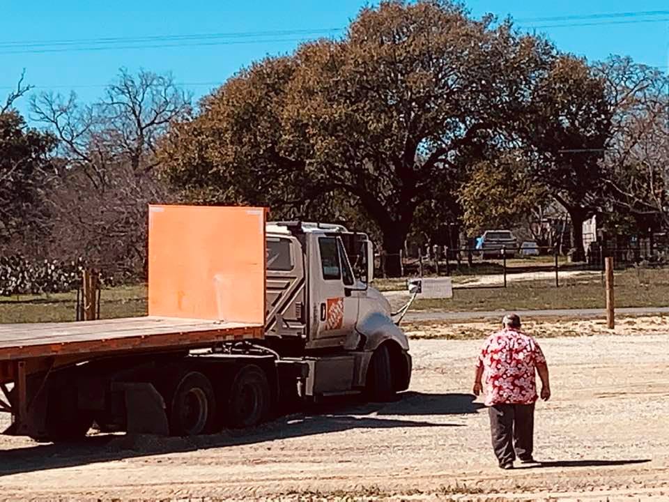 David walked out to tell the guy to call a tow truck. From experience (10 others have been stuck in the sand since we moved here, we know there is no other way out when you are in that deep.
