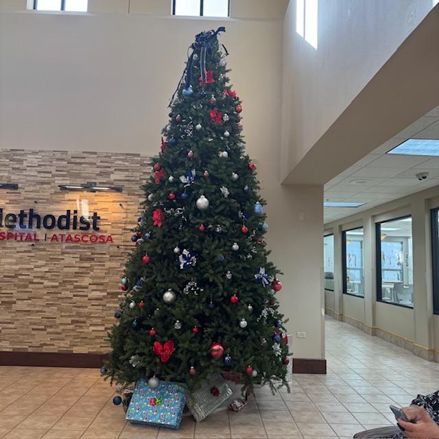 This huge Christmas tree graces the lobby at the Atascosa County hospital. David's hand and phone are in the foreground.