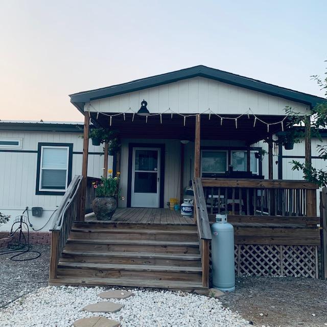 The front porch of our home with a bunch of propane tanks waiting to take to be refilled. The propane is for grilling and heating the greenhouse in winter.