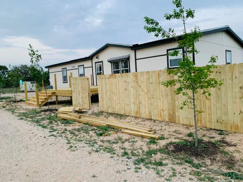 Our fence was extended from the orchard to the front of the house on the right side.
