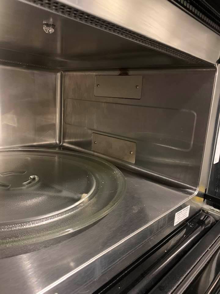 The inside of the Whirlpool microwave with the new piece.
