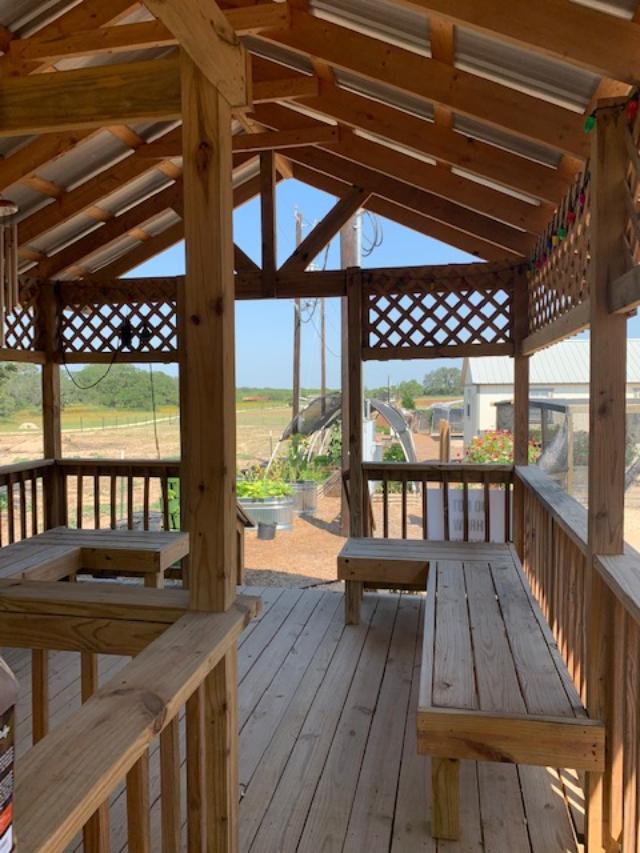 Inside the gazebo are wooden seats.