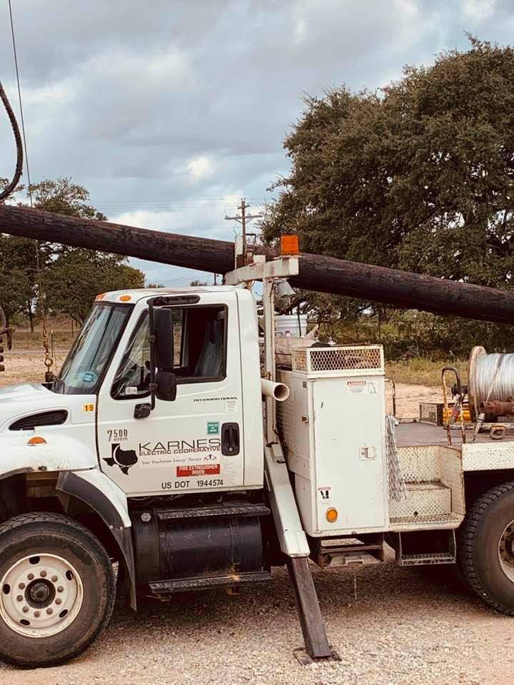 The electric company with one of three poles they put up in our yard.