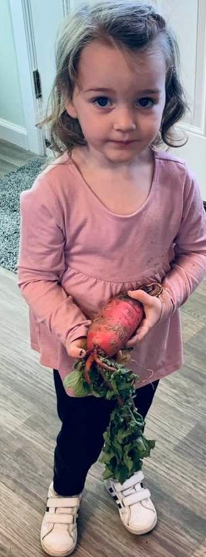 Jubilee with a King radish that David picked on the tour.