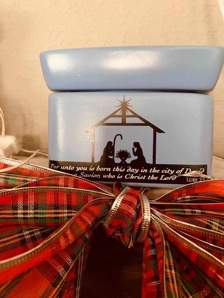 My Christmas Scentsy wax melter is on the hearth with a big bow. It looks so pretty.