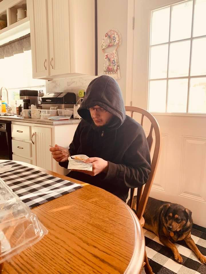 Annabelle is guarding Matt while he eats in our kitchen.