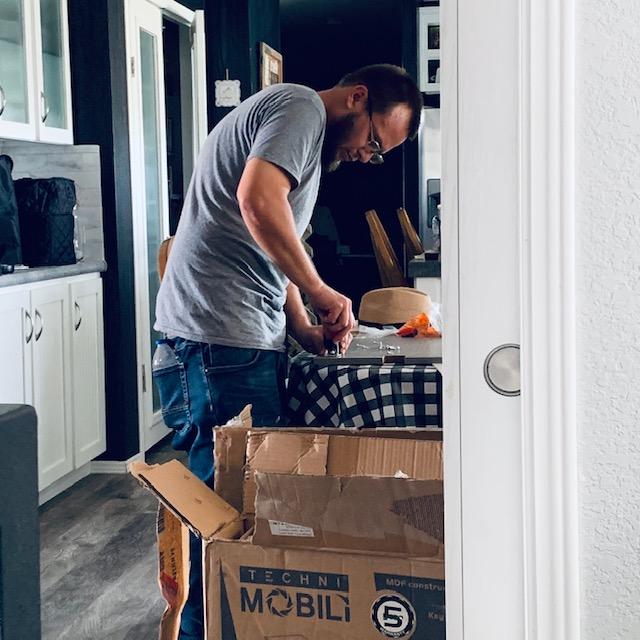 Matt just beginning to put 2 printer tables together. So many pieces, so little time. I appreciate him giving up most of his day off to help me.