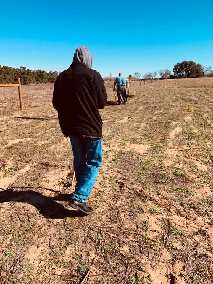 Matt, David, and Annabelle behind the house and garden area making farm plans for the property.