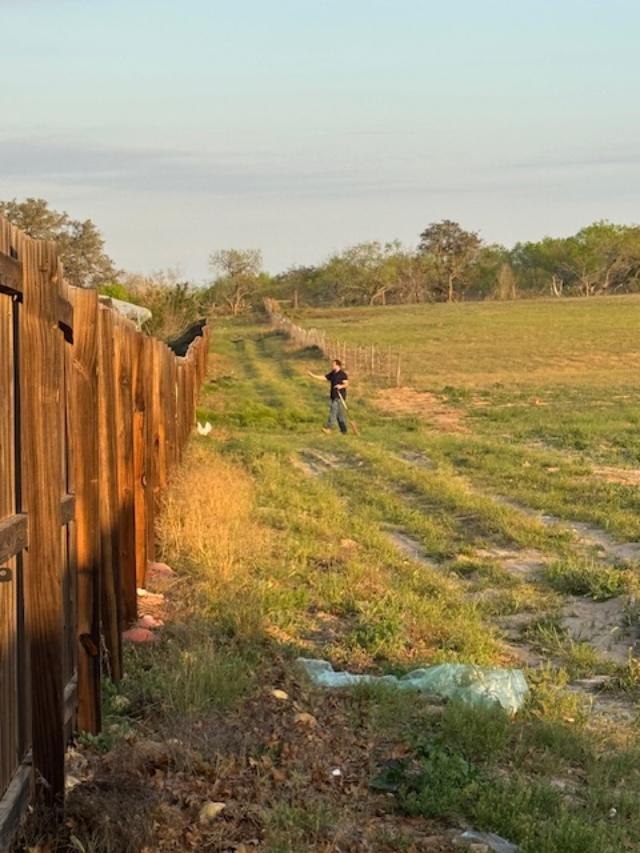 Matt corralling a chicken back into its yard.