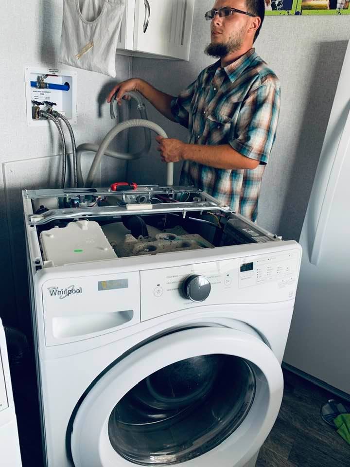 Matt came to the rescue, taking the washer apart so I could get a lot of my clothes out of this piece of garbage. It is not even 3 years old.