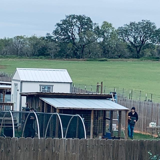 Our son, Matt, starting to put plastic up around the animal pens to keep the icy wind out.