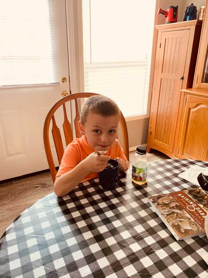Max is eating his brownie in a mug.