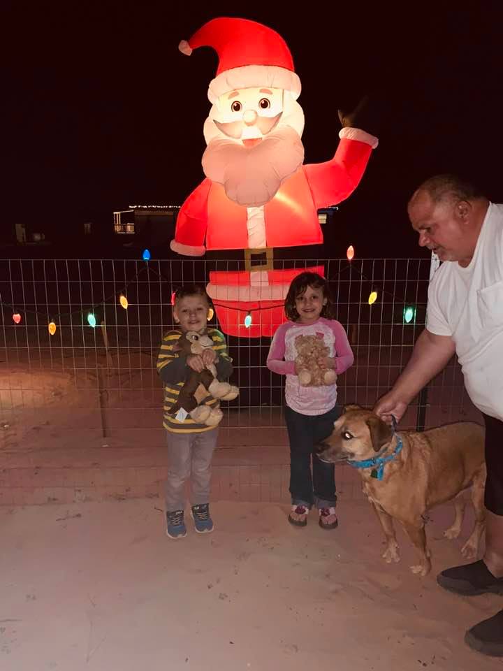 Max, Holley, Lucy, and David with giant Santa in front of our home.