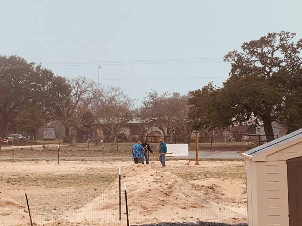 David and some of the crew are plotting where the septic tank, store, and restrooms will be. They marked them with sticks.