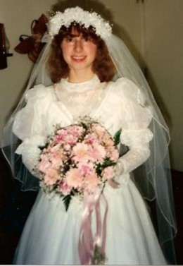 Me on my wedding day with a beautiful bouquet of pink daisies mixed with carnations.