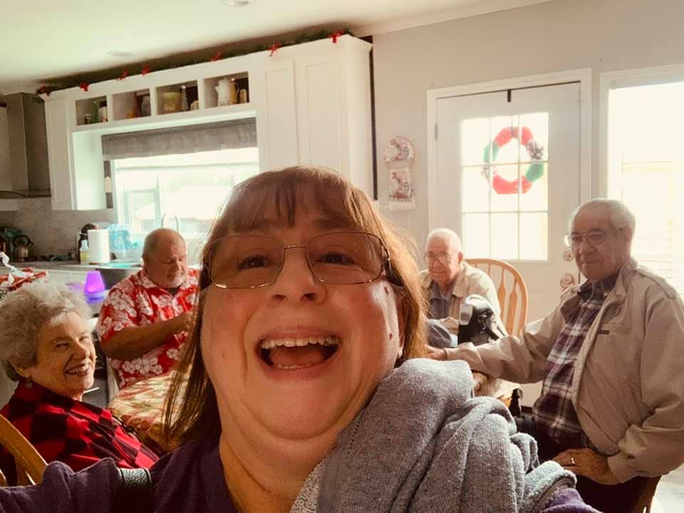 Juanita in front, Ruth Anne left, David, David's father John, Clyde at our dining table. We still had Christmas up.