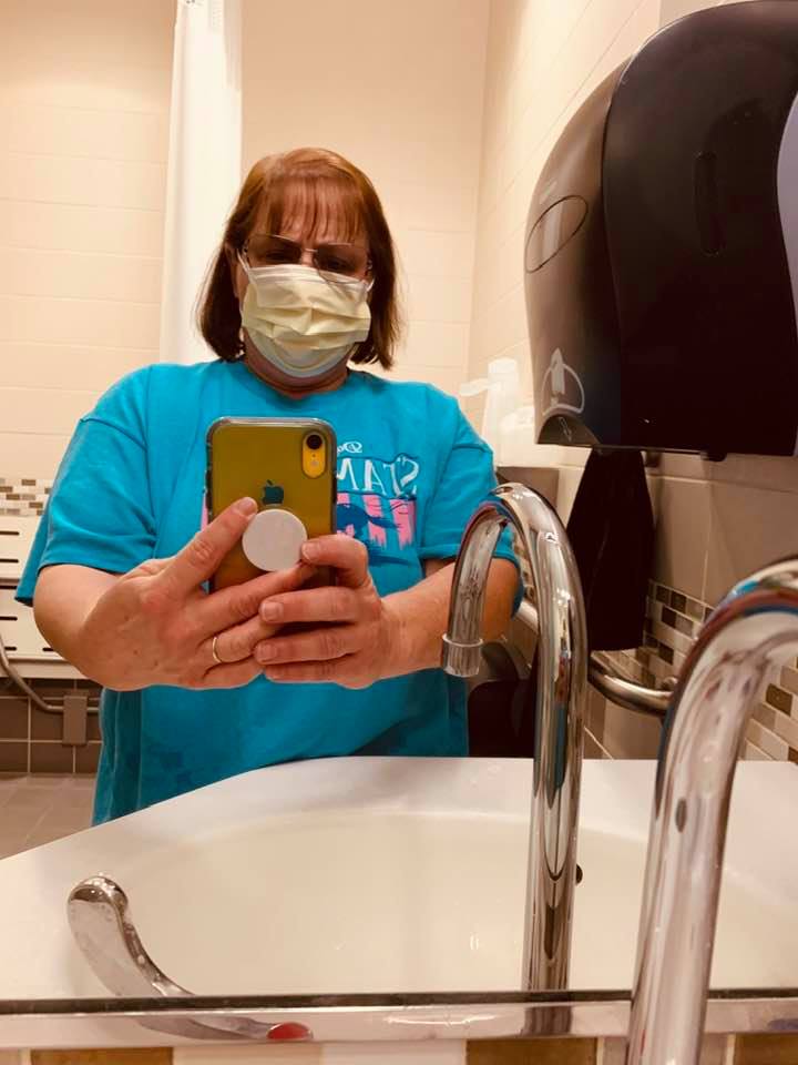 Juanita in the ICU bathroom with mask on. Masks were required because they think Matt may have an infection.