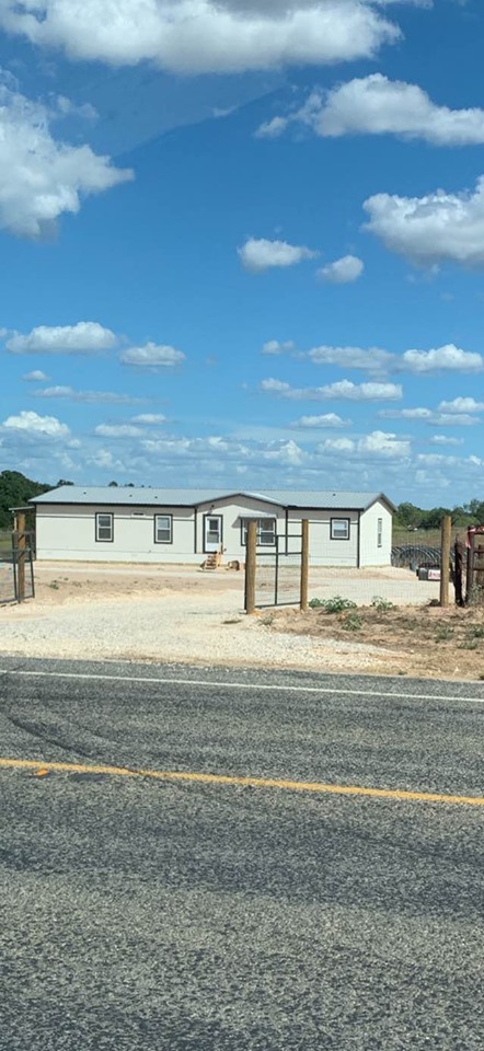 This is a photo of our home here on the farm before we got all of the business buildings. It is larger than the 4 bedroom home we built in San Antonio. We love it.