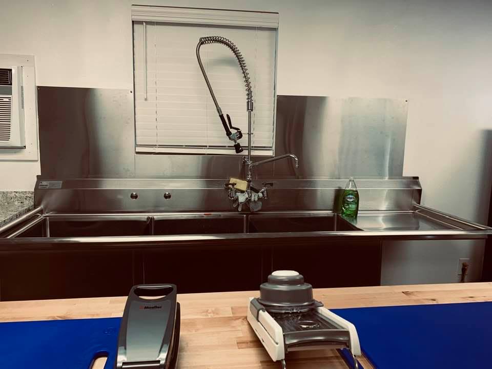 Our monstrous 3 section commercial kitchen sink with a stainless steel backsplash is now ready to use.