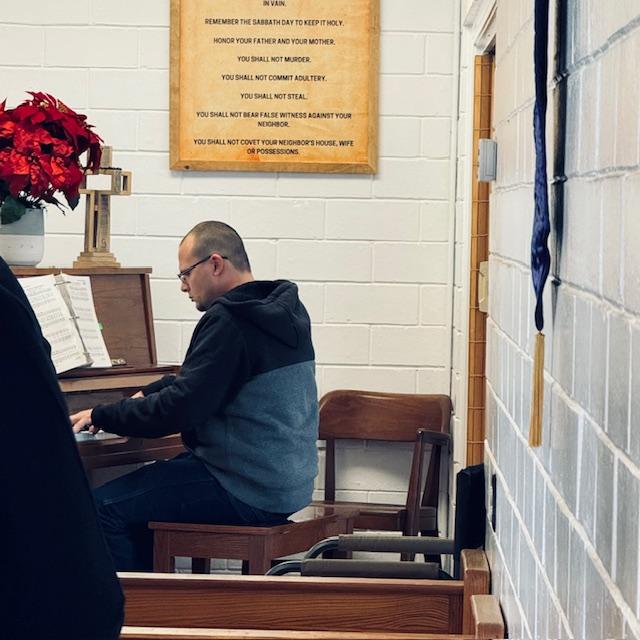 Matt playing the piano at Sand Branch Baptist Church.