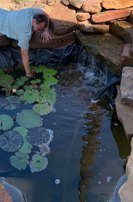 Sometimes, you have to get down in there and pull stuff out. With children visiting the pond, it can get filled with a lot of unnatural things as well as flowers, sticks, & oak pollen pods.