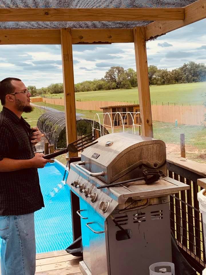Our son, Matthew, grilling steaks on the back deck for us, just moments before the fire came up and the plate went in my pool!