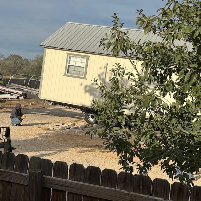 The crew from Austin did not fool around. They took down part of our fence and began lifting Production and putting wheels under it.