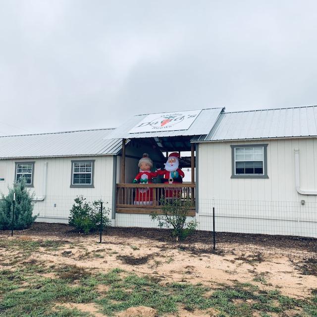 I thought it would look good to have Santa and the Mrs. waving at passersby on the deck. Note the business sign overhead.