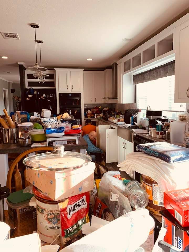 The Shelf Confident guys are putting pull out drawers in my kitchen cabinets. All of the cabinets had to be emptied.