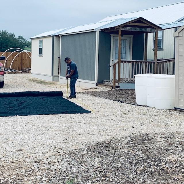 Here is some shade cloth being laid out on the driveway to measure and cut. Nacho put a lot of it up for us. Here is some shade cloth being laid out on the driveway to measure and cut. Nacho put a lot of it up for us.