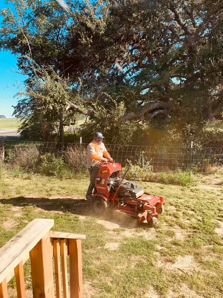 Nacho from Top Notch Lawn Care riding by on a standing lawn mower. Until today, I had never seen one.