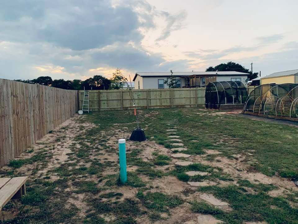 A new fence is going up across the backyard. It will make the dog yard bigger and it will also block the dogs from getting out when David takes them up into the "back 40".