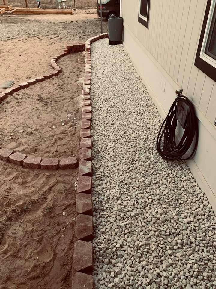 This photo shows the new retaining wall outline as well as the flowerbed outline for my rosebushes.