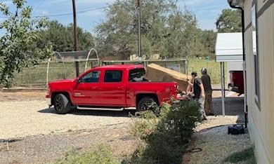 Andy and his assistant with the new water heater in the box. We've used Andy for home repairs when we lived in San Antonio.
