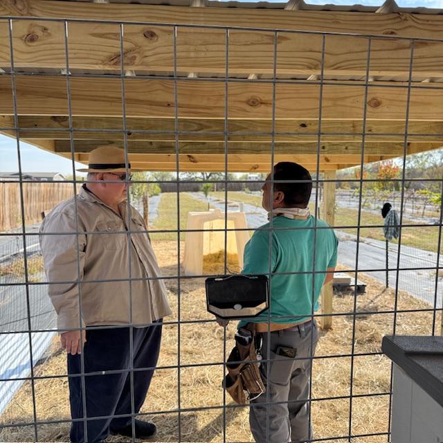 David and Nacho discuss what other chores need to be done under Norton's new covered area. Shot from the girl's shelter.