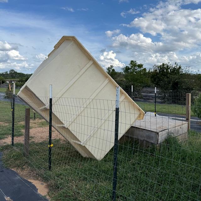 Norton's shelter was turned upside down and blown up on the fence from our little cyclone or whatever it was.