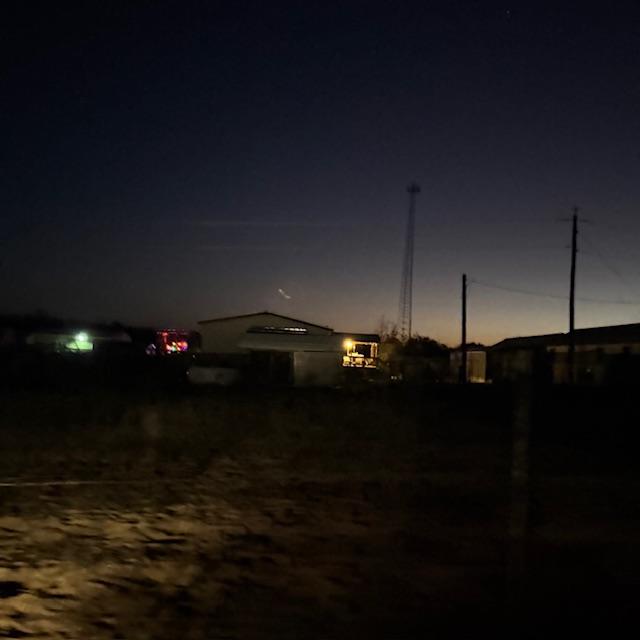 We are a bit further back toward the road now & it is not blurry. I am trying to show how far away our groceries were. Thank God she left the porch light on or we would have had trouble seeing.