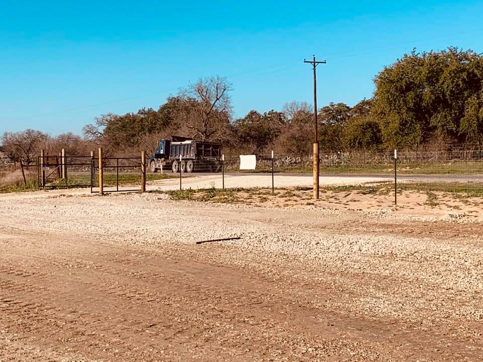 Another dump truck with gravel showed up. They always overshoot our driveway and have to back up.