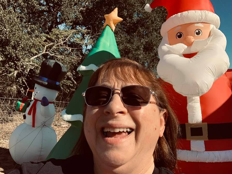 Mrs. David's Garden Seeds® photobombing Santa, the tree, and Frosty in front of our farm store, ready for Christmas!