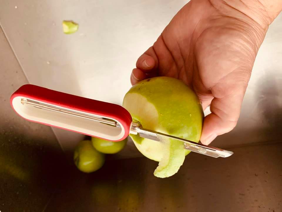 Here I am using a vegetable peeler to peel a Granny Smith apple.
