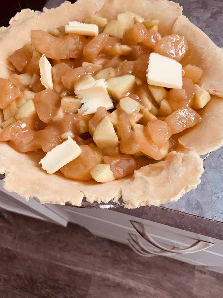 Add your filling. This is an apple pie filling with dots of butter on top.